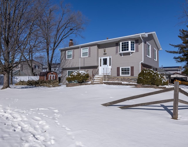 split foyer home with a shed