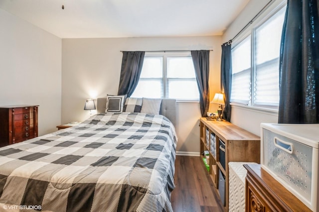 bedroom with baseboards and wood finished floors