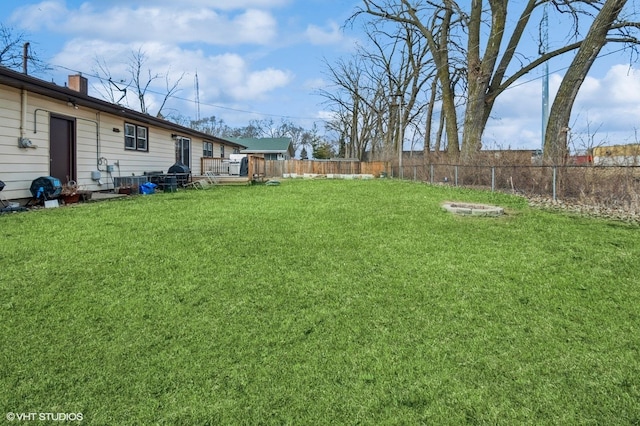 view of yard with fence and a wooden deck