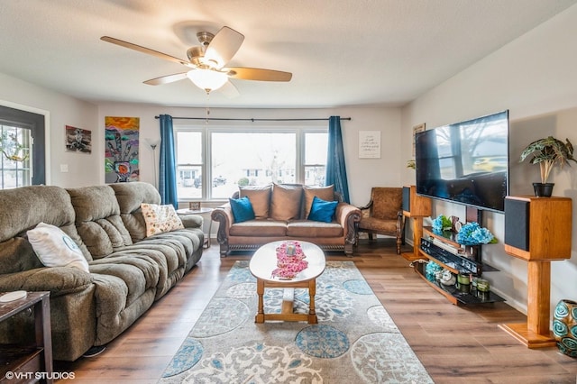 living room featuring wood finished floors and a ceiling fan