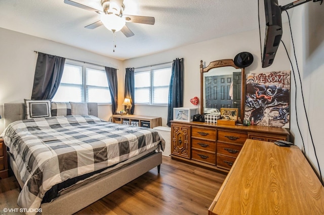 bedroom featuring wood finished floors and a ceiling fan