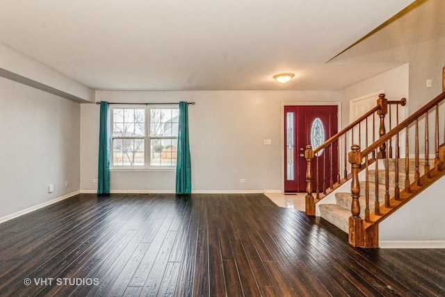 entryway featuring baseboards, stairway, and hardwood / wood-style floors