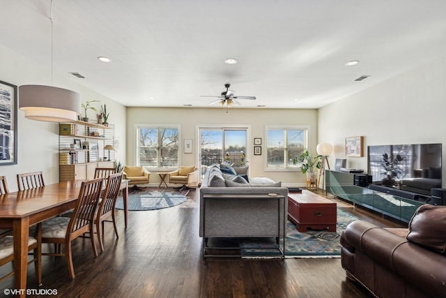 living area featuring a ceiling fan, wood finished floors, visible vents, and recessed lighting