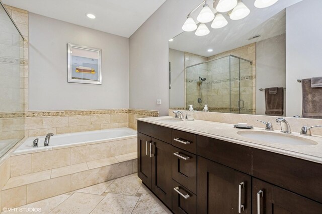 full bath featuring double vanity, a garden tub, a shower stall, and a sink