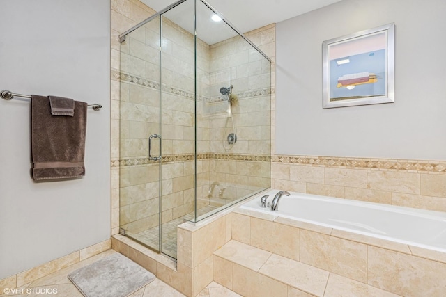 full bath with tile patterned flooring, a garden tub, and a shower stall