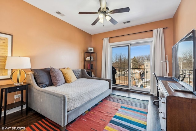 bedroom with access to exterior, a ceiling fan, visible vents, and wood finished floors