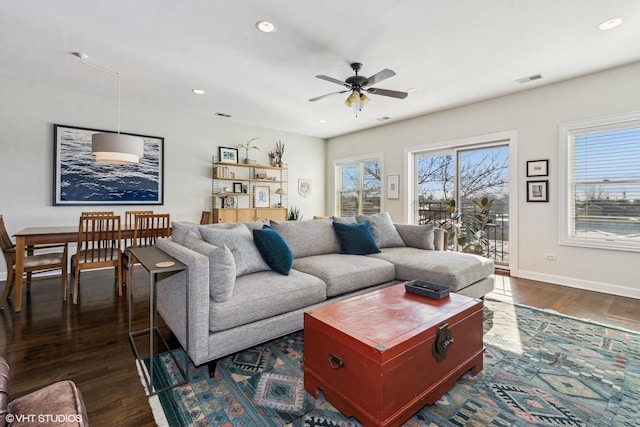 living room with baseboards, plenty of natural light, dark wood finished floors, and recessed lighting