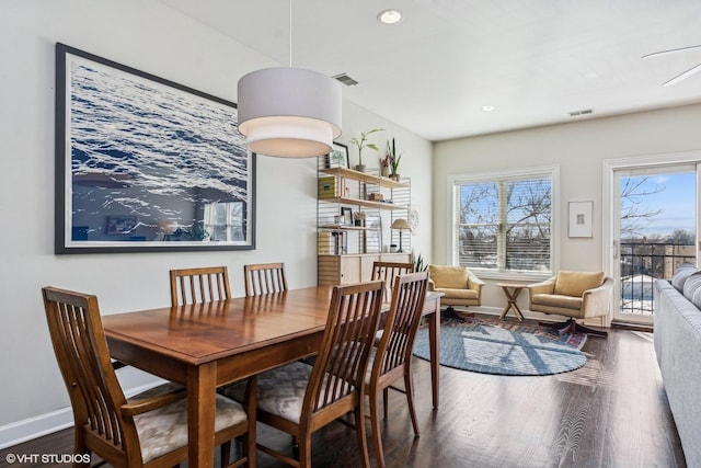 dining room featuring visible vents, plenty of natural light, and wood finished floors