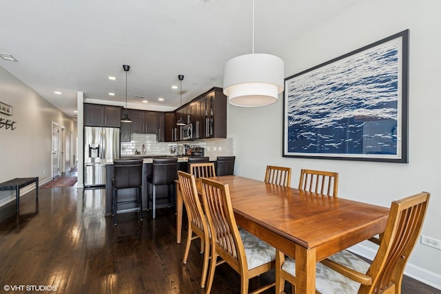 dining area with dark wood-type flooring, recessed lighting, visible vents, and baseboards