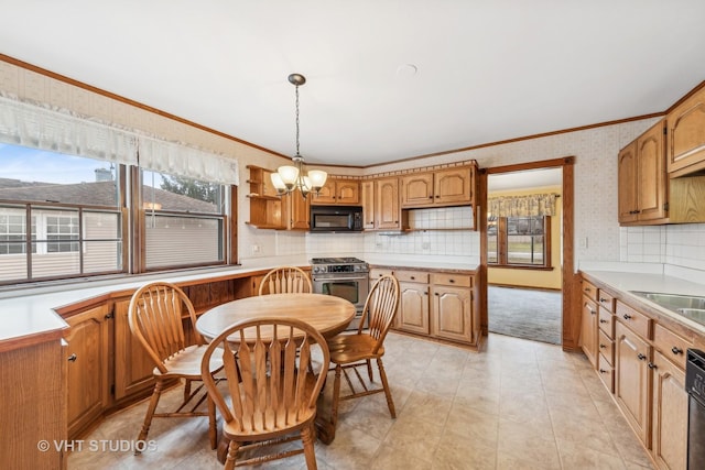 dining space featuring ornamental molding, sink, and a notable chandelier