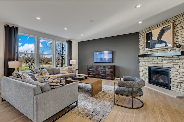 living room featuring a fireplace and light hardwood / wood-style floors