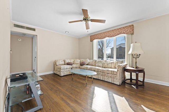 living room with crown molding, ceiling fan, and dark hardwood / wood-style floors