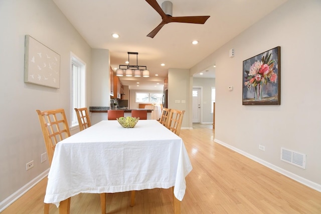 dining room with baseboards, visible vents, a ceiling fan, light wood-type flooring, and recessed lighting