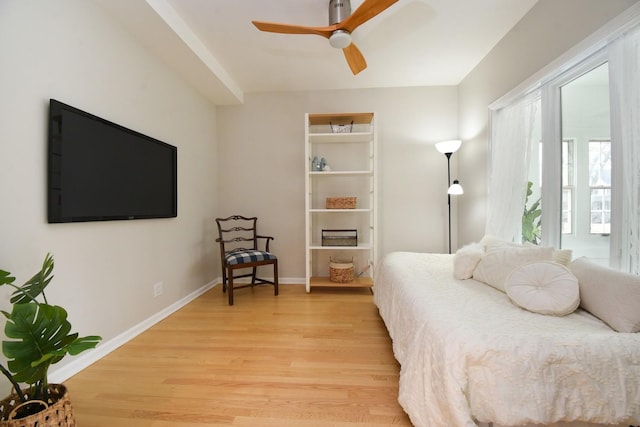 bedroom featuring light wood finished floors, ceiling fan, and baseboards