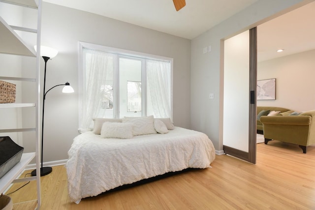 bedroom with recessed lighting, light wood-type flooring, a ceiling fan, and baseboards