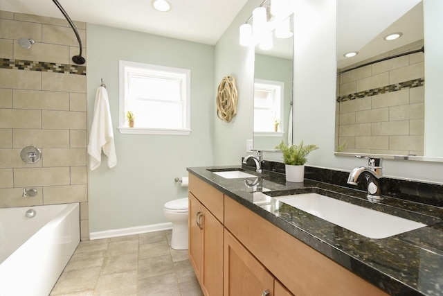 full bathroom with toilet, baseboards,  shower combination, and a sink