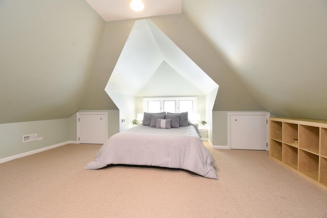 carpeted bedroom with visible vents, baseboards, and vaulted ceiling