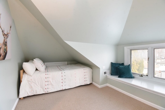 unfurnished bedroom with lofted ceiling, carpet floors, visible vents, and baseboards