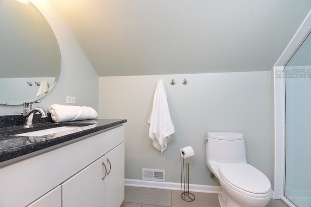 full bathroom with visible vents, toilet, vaulted ceiling, vanity, and baseboards