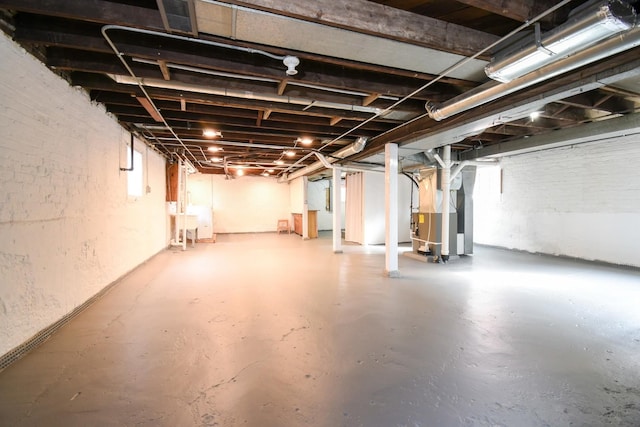 basement with heating unit and plenty of natural light