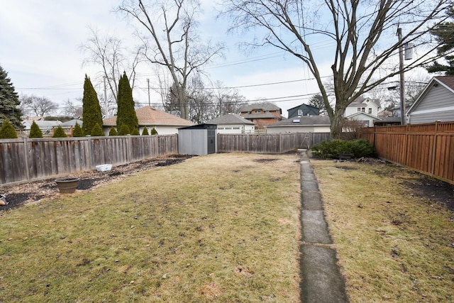 view of yard featuring a shed, an outdoor structure, a fenced backyard, and a residential view