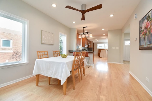 dining space featuring light wood finished floors, recessed lighting, a ceiling fan, and baseboards