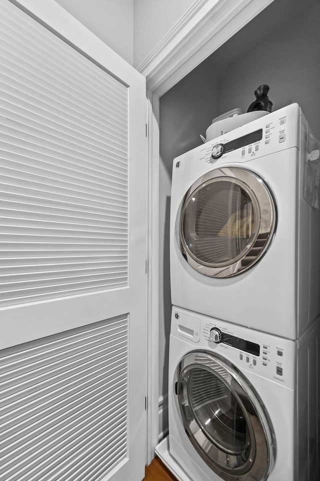 washroom featuring stacked washer / dryer