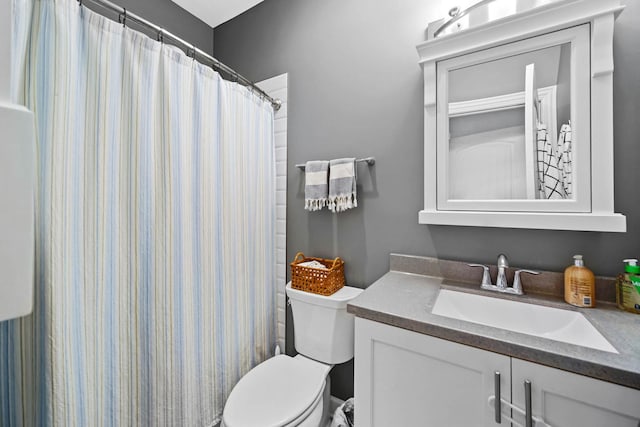 bathroom featuring vanity, a shower with shower curtain, and toilet