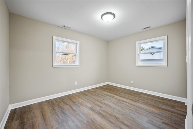 unfurnished room featuring hardwood / wood-style floors and a wealth of natural light