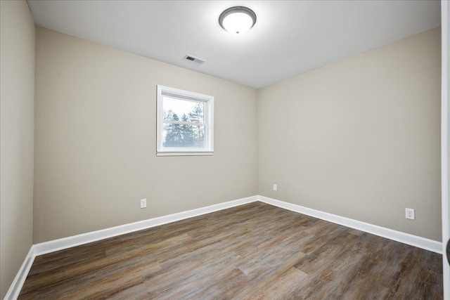 spare room with hardwood / wood-style floors