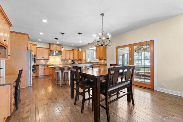 dining room with baseboards, a chandelier, dark wood-type flooring, and recessed lighting