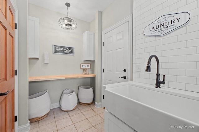 bathroom featuring tile patterned flooring and baseboards