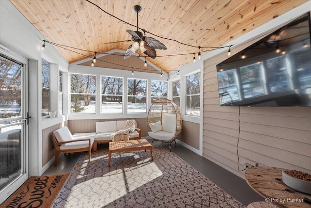 sunroom / solarium with lofted ceiling, wood ceiling, and a ceiling fan