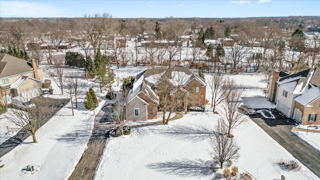 snowy aerial view featuring a residential view