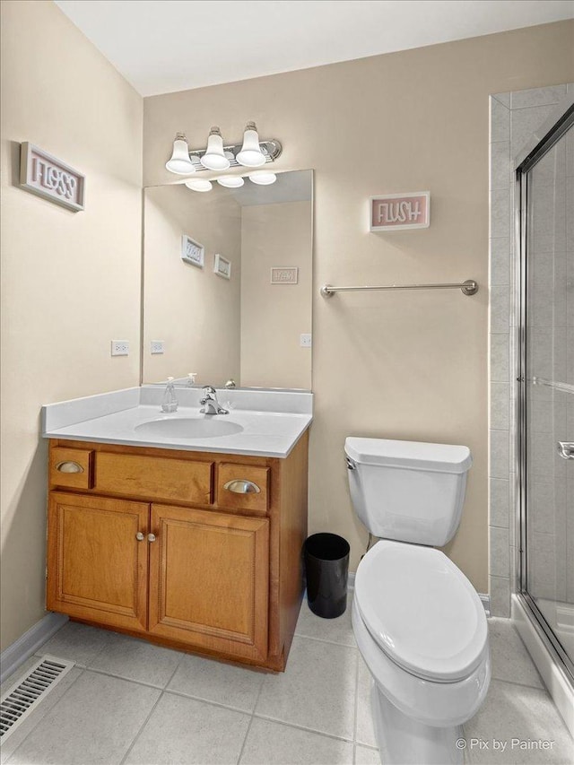 full bath with visible vents, toilet, a stall shower, vanity, and tile patterned floors