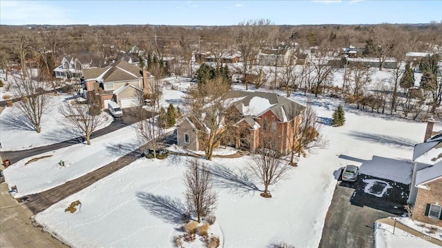 snowy aerial view with a residential view