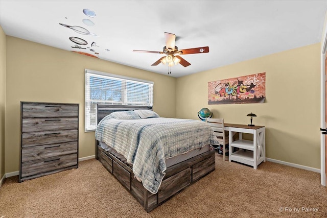 carpeted bedroom featuring baseboards and a ceiling fan