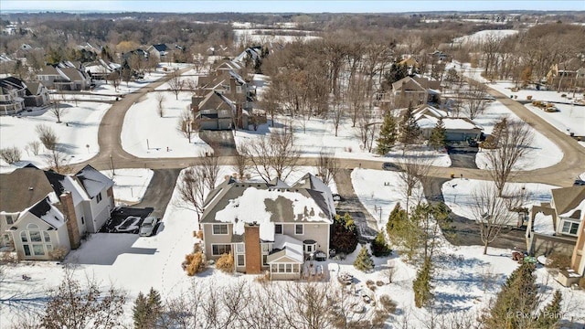 snowy aerial view featuring a residential view