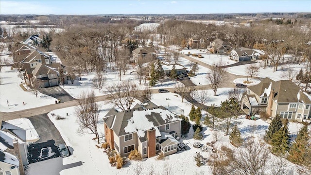 snowy aerial view featuring a residential view