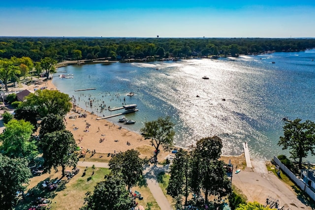 drone / aerial view with a water view and a forest view