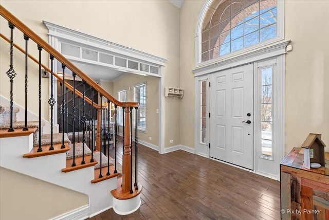 entrance foyer with baseboards, hardwood / wood-style floors, and a healthy amount of sunlight