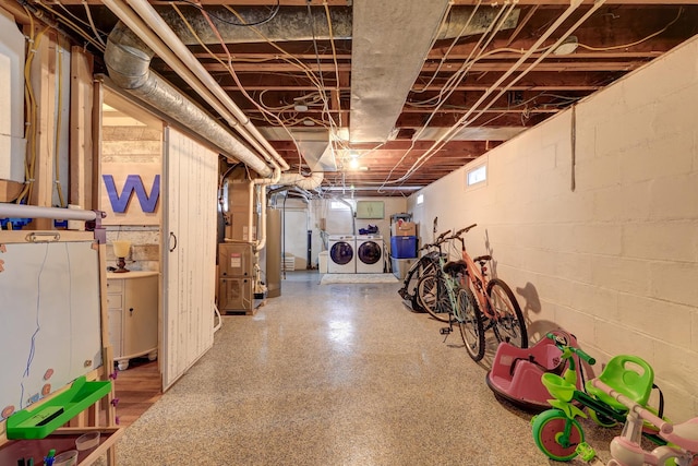 basement with washing machine and dryer and heating unit