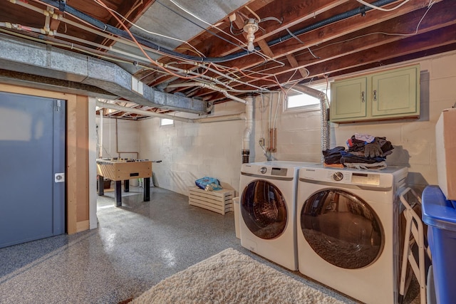 laundry area featuring cabinets, sink, and washing machine and clothes dryer