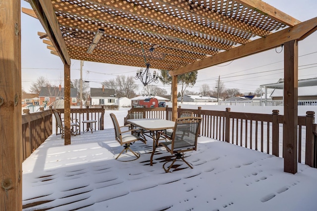 snow covered deck with a pergola