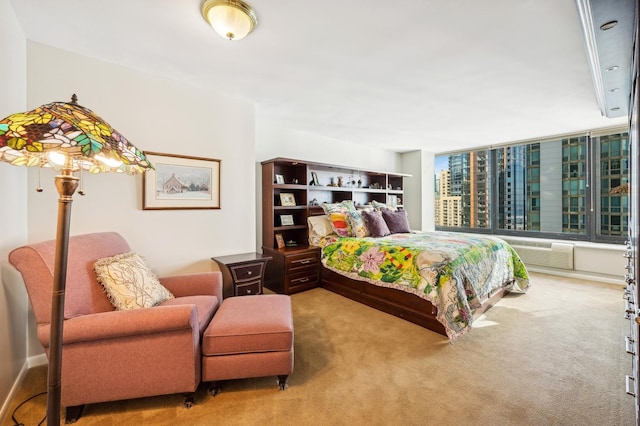 carpeted bedroom with an AC wall unit