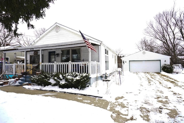 view of front of property featuring a garage, an outbuilding, and covered porch