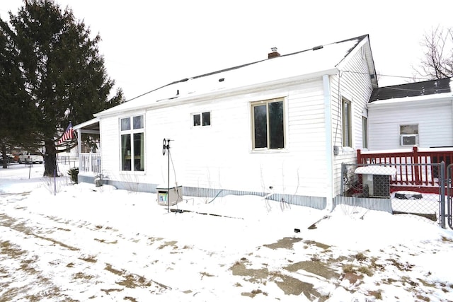 view of snow covered back of property