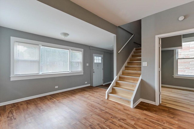 entrance foyer with hardwood / wood-style flooring and a wealth of natural light