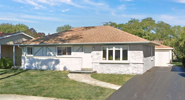 view of front of home featuring a garage and a front lawn