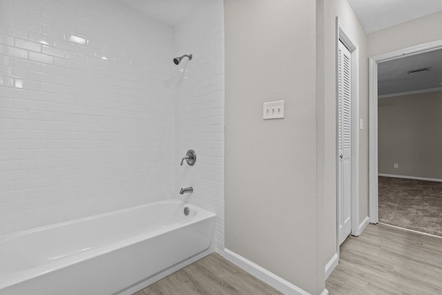 bathroom featuring hardwood / wood-style flooring and tiled shower / bath combo